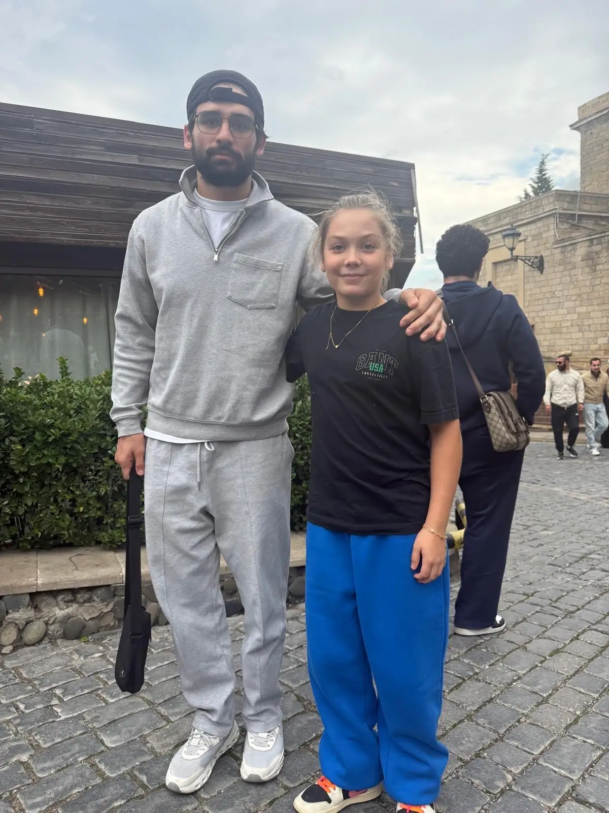 Melissa and a man in a group photo on the street