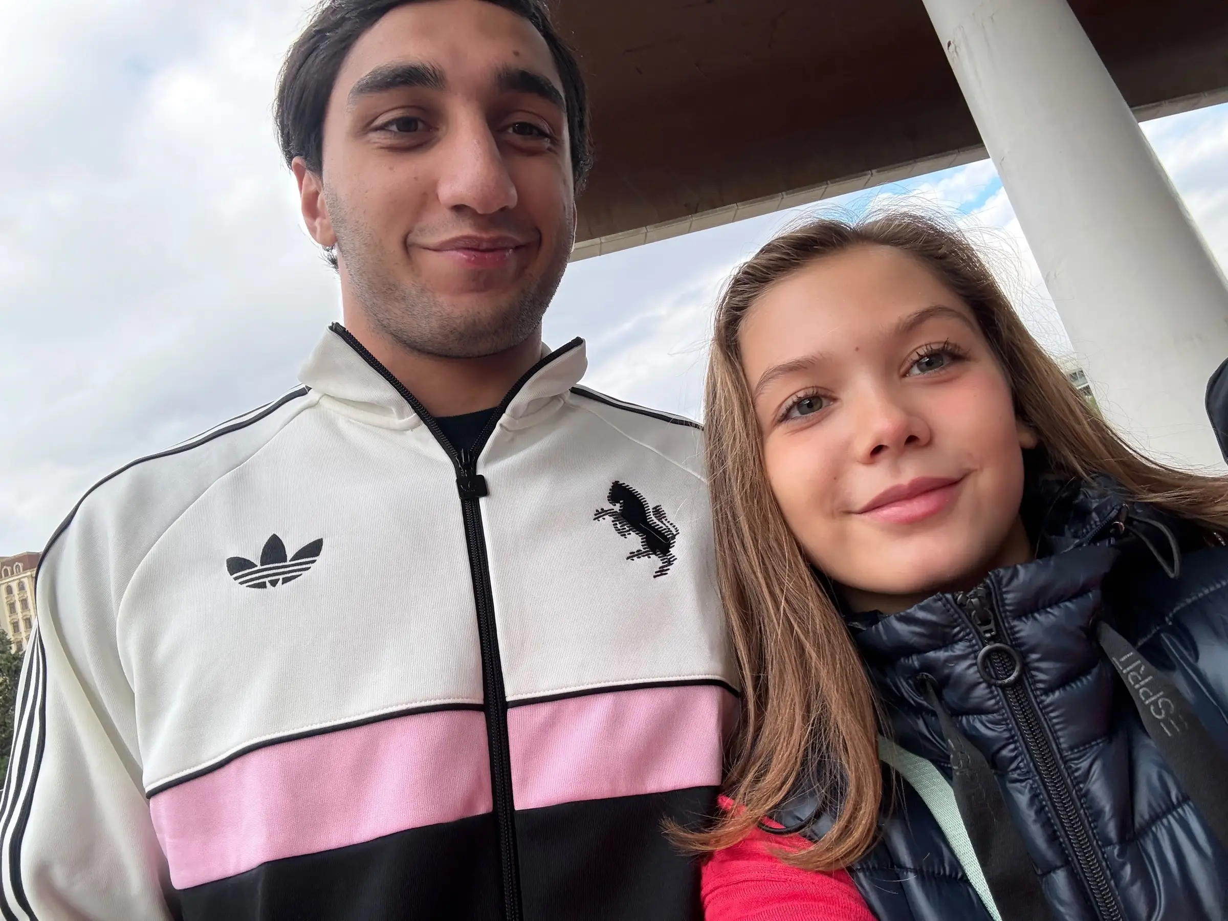 Melissa and a young man in a selfie, both smiling
